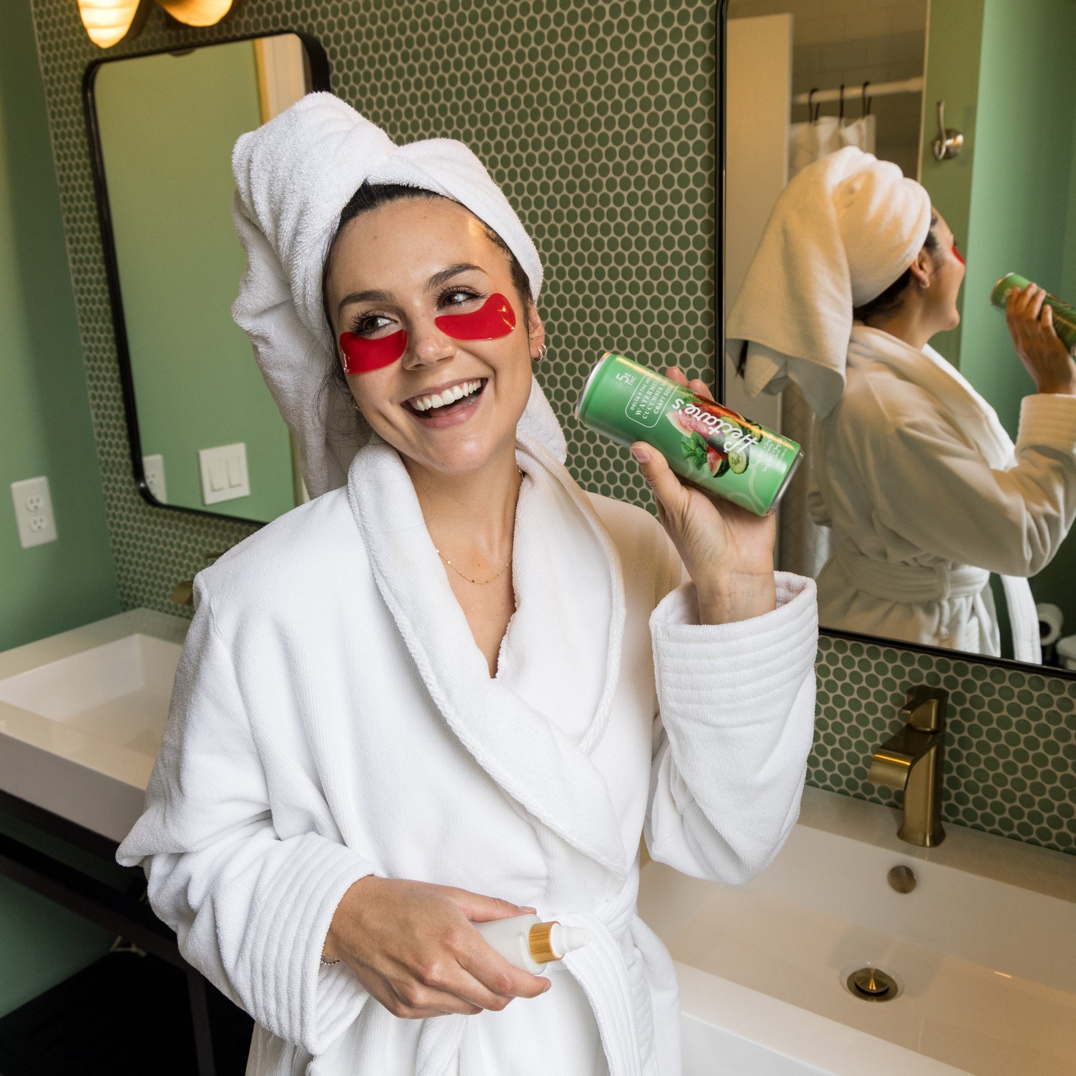 Woman in a bathrobe with towel on head, holding a can of Hectare's Watermelon Cucumber Mint Delta 9 Craft Soda in a bathroom getting ready. 